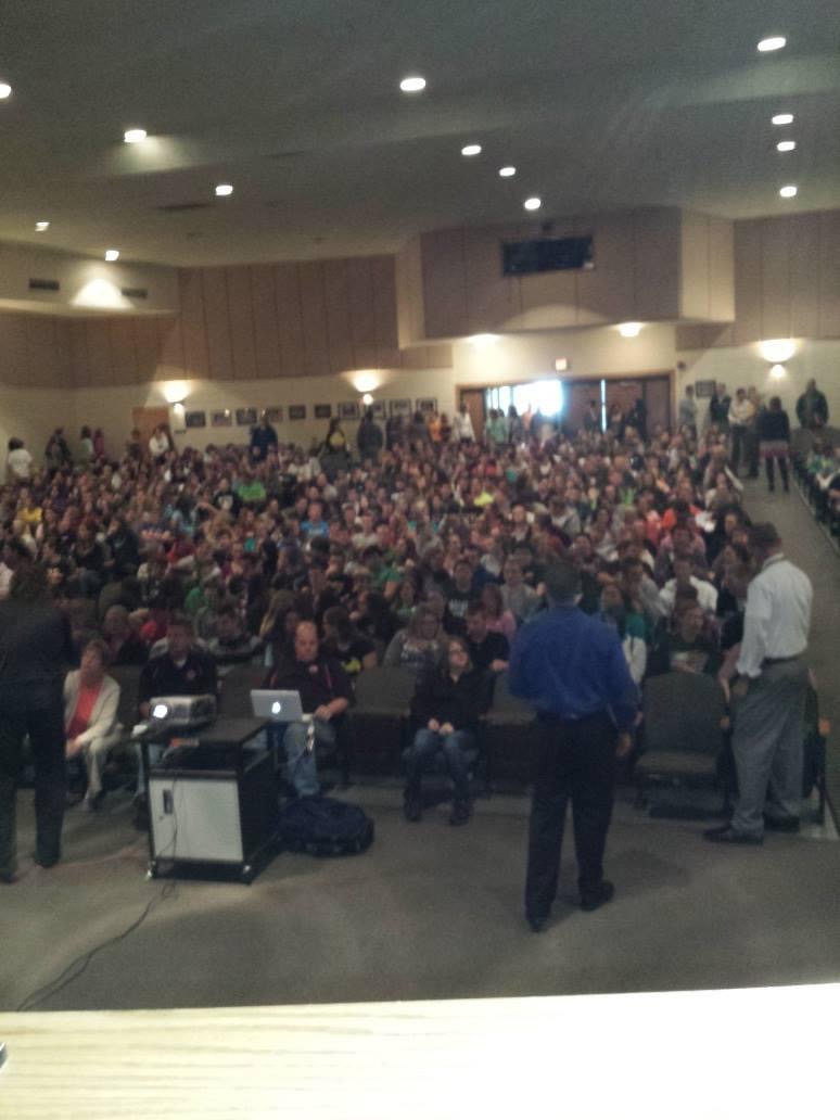 Full auditorium crowd during a school assembly