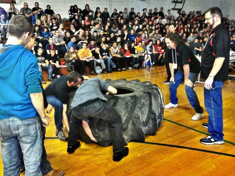 Students flipping a tire during an interactive session